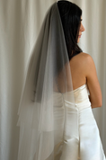 Bild in Galerie-Betrachter laden, Bride wearing a white wedding dress with a plain veil against a white curtain background.