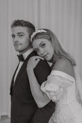 Load image into Gallery viewer, Black and white photo of a couple in formal attire, likely at a wedding.
