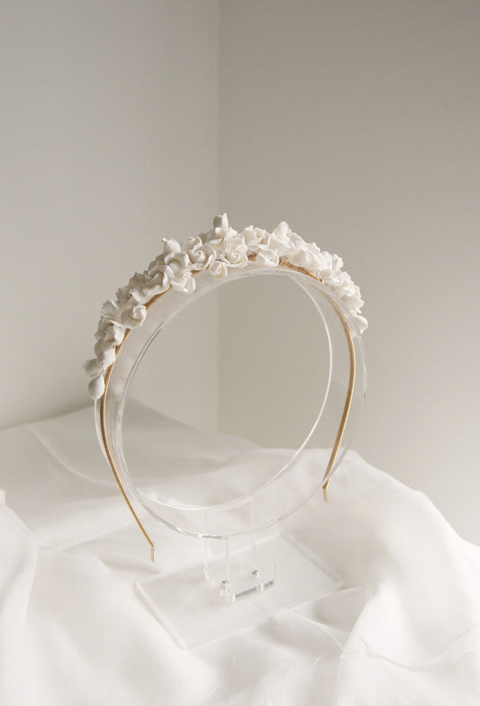 Floral headband on a white surface with a neutral background