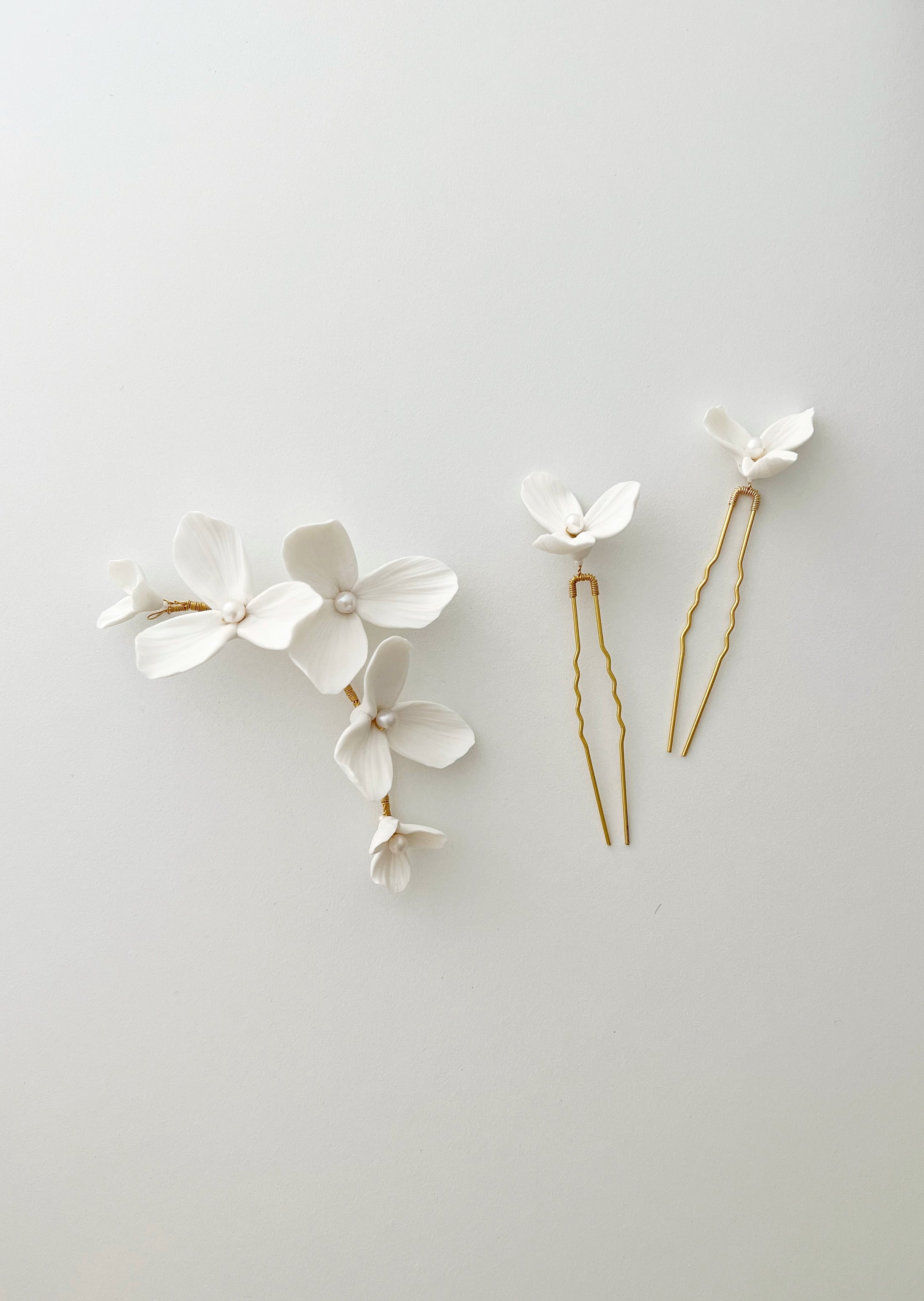 Set of floral hairpins on a light gray background