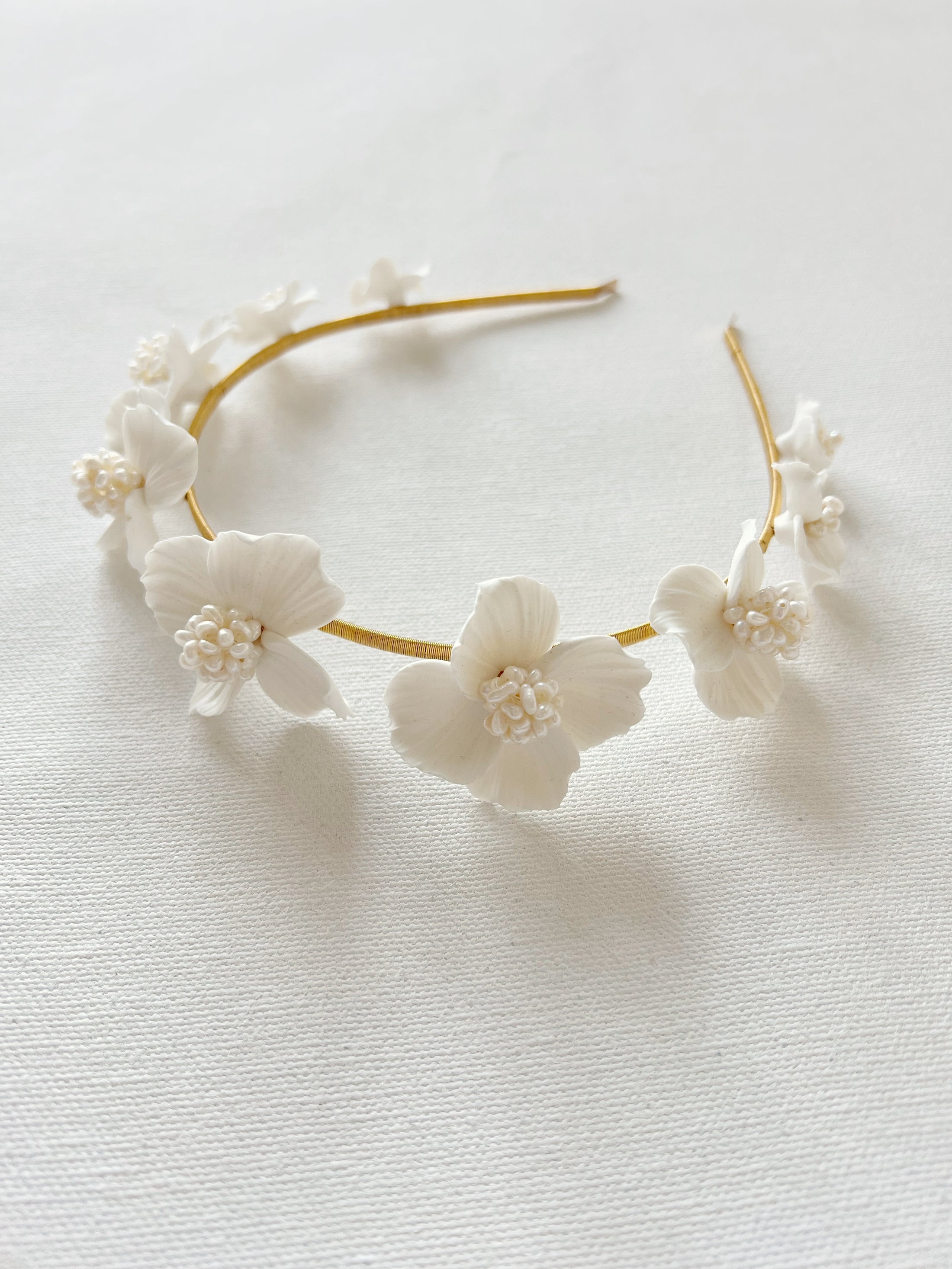 Floral headband with white flowers on a light background