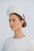 Load image into Gallery viewer, Woman wearing a white bridal headband against a light grey background
