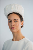 Load image into Gallery viewer, Woman wearing a white bridal headband against a light grey background
