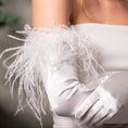 Load image into Gallery viewer, White glove with feather details on a blurred background
