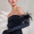 Load image into Gallery viewer, Woman wearing a black off-shoulder dress with feather details against a neutral background
