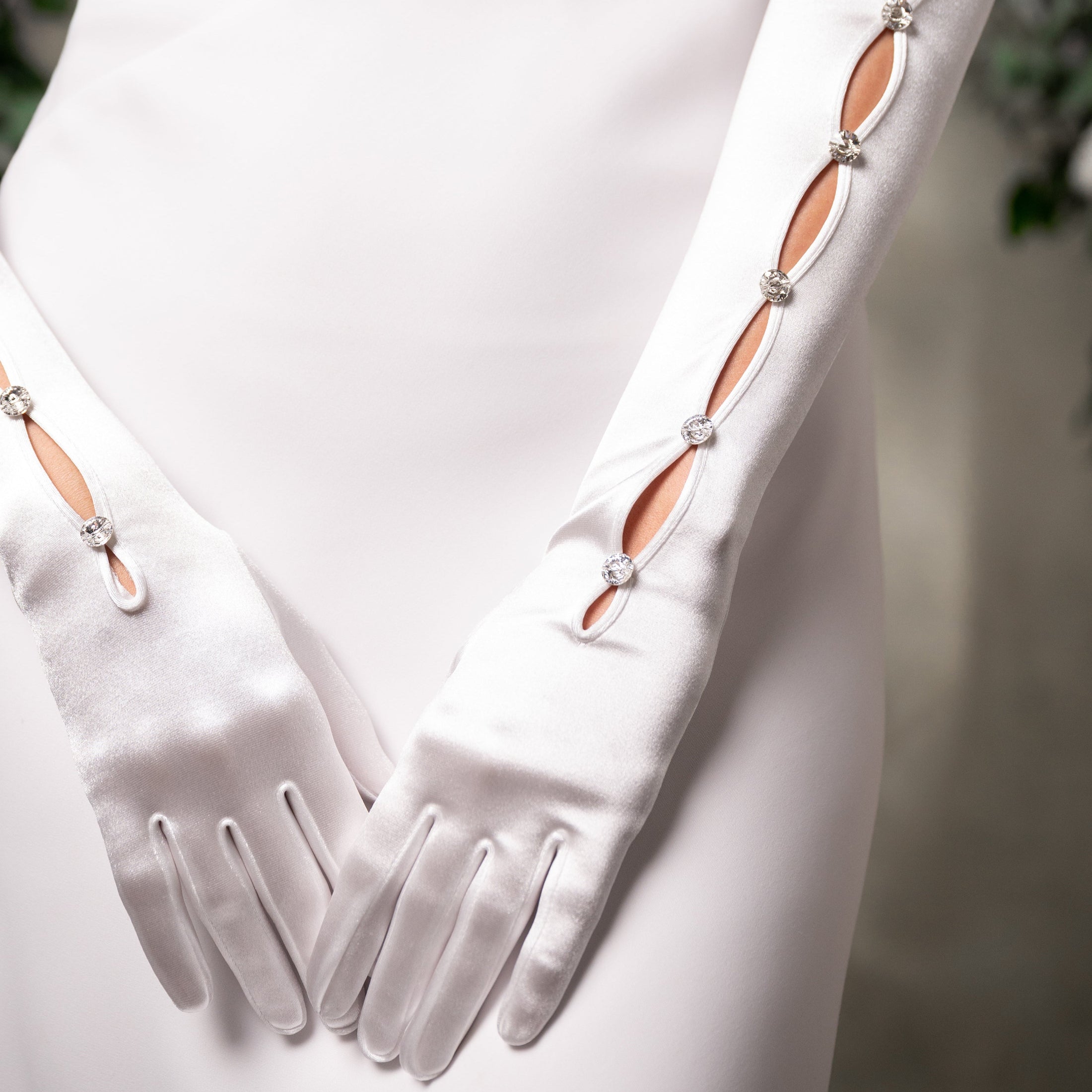 White gloves with decorative elements on a white background