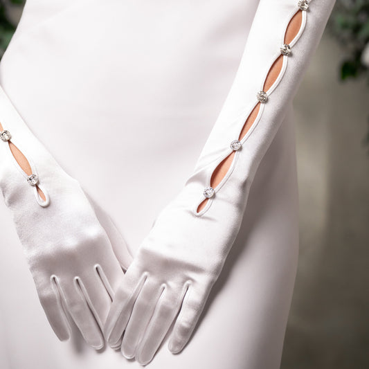 White gloves with decorative elements on a white background