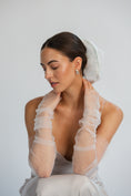 Load image into Gallery viewer, Bride wearing sheer white gloves and bridal hair scrunchie against a plain background
