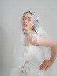 Load image into Gallery viewer, Woman wearing a white wedding dress with a lace veil against a plain background
