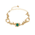 Load image into Gallery viewer, Gold bracelet with an emerald on a white background
