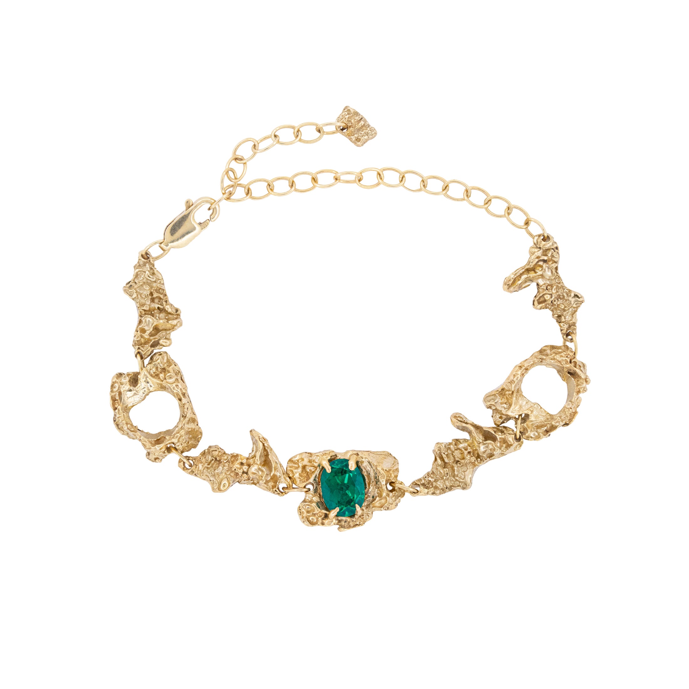 Gold bracelet with an emerald on a white background