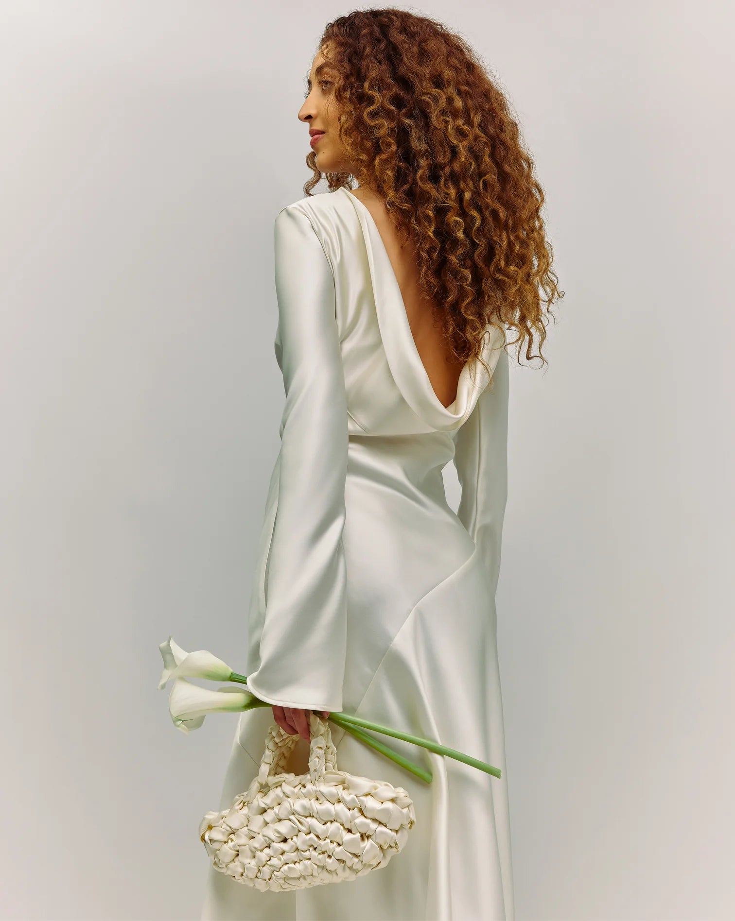 bride wearing nest handbag in white