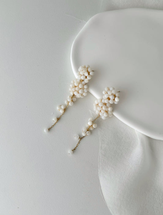 Pearl hairpins on a white surface