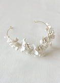 Load image into Gallery viewer, White floral headband on a light gray background
