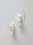 Load image into Gallery viewer, White ceramic earrings with gold accents on a light gray background
