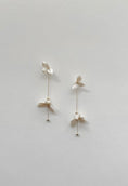 Load image into Gallery viewer, Pair of delicate earrings on a light gray background

