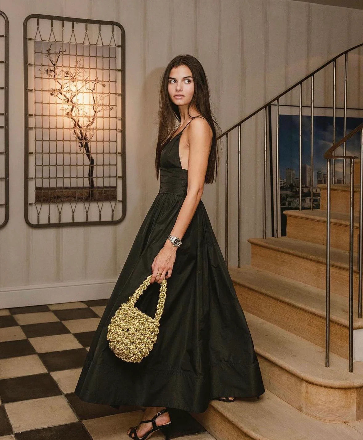 woman wearing hive metallic handbag in gold