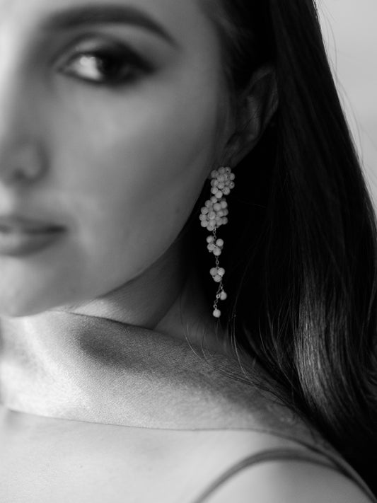 Close-up of a woman wearing elegant earrings with a blurred background