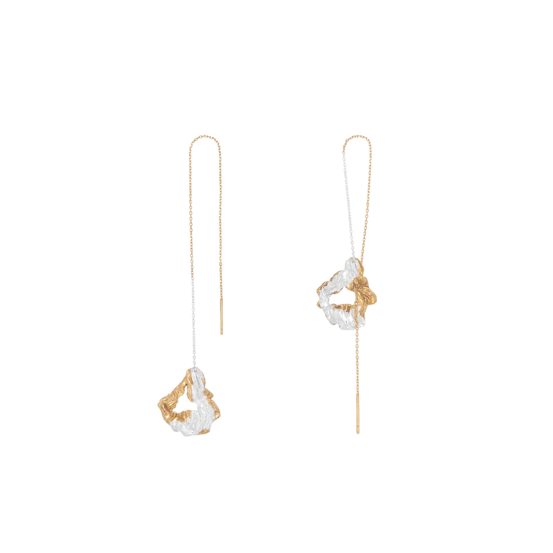 Gold and silver earrings on a white background