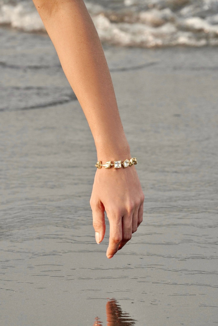 woman wearing gold bracelet