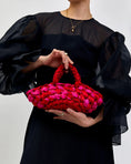 Load image into Gallery viewer, woman holding nest handbag in red and pink
