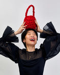 Load image into Gallery viewer, woman wearing hive handbag in red
