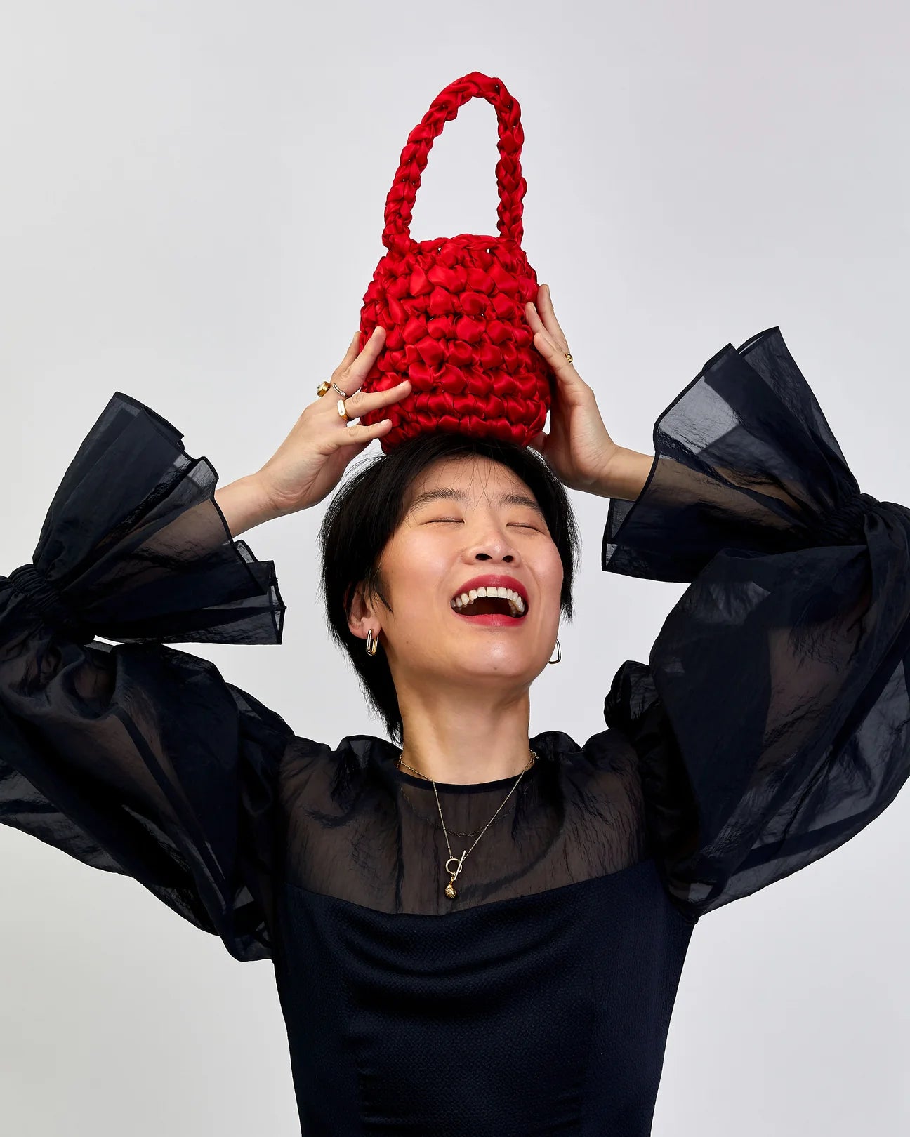woman wearing hive handbag in red