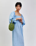 Load image into Gallery viewer, woman wearing hive handbag in spring moss
