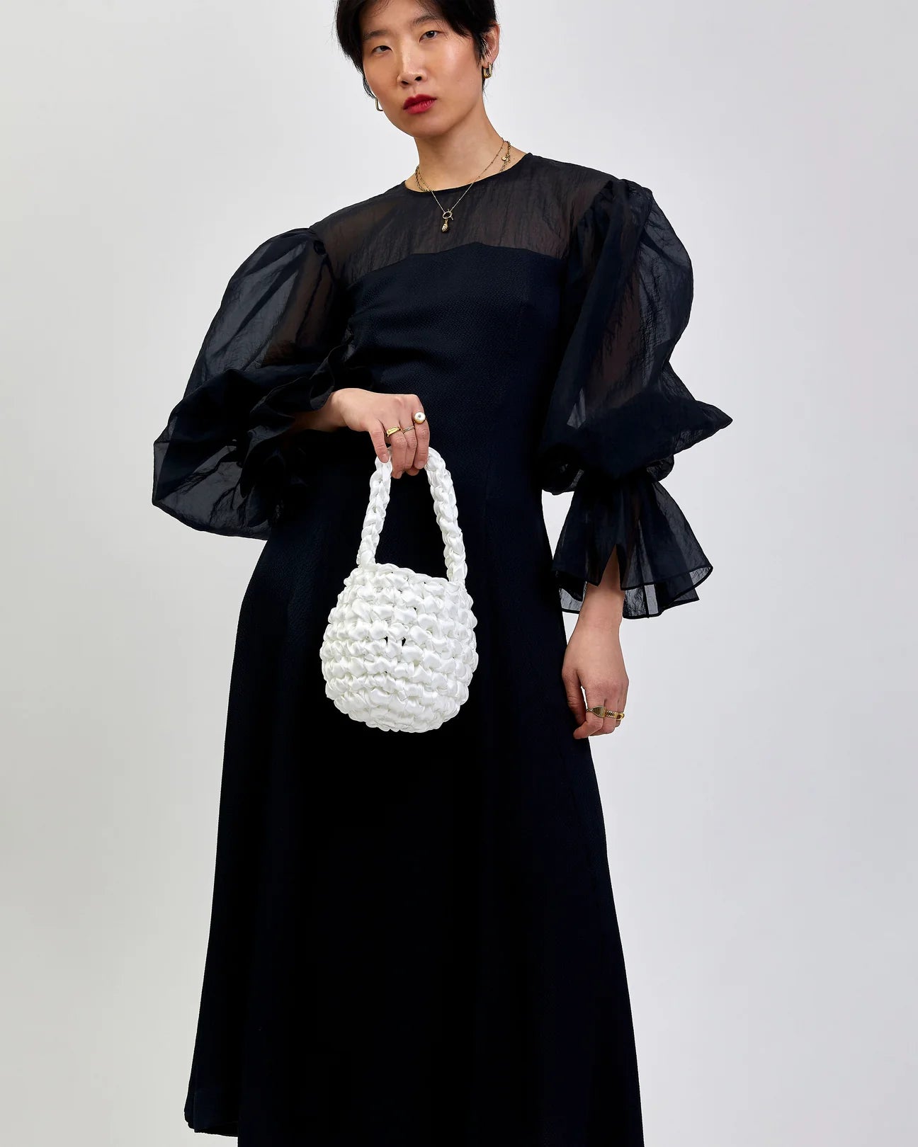 woman wearing Hive handbag in bright white