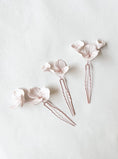 Load image into Gallery viewer, Three floral hairpins on a light gray background
