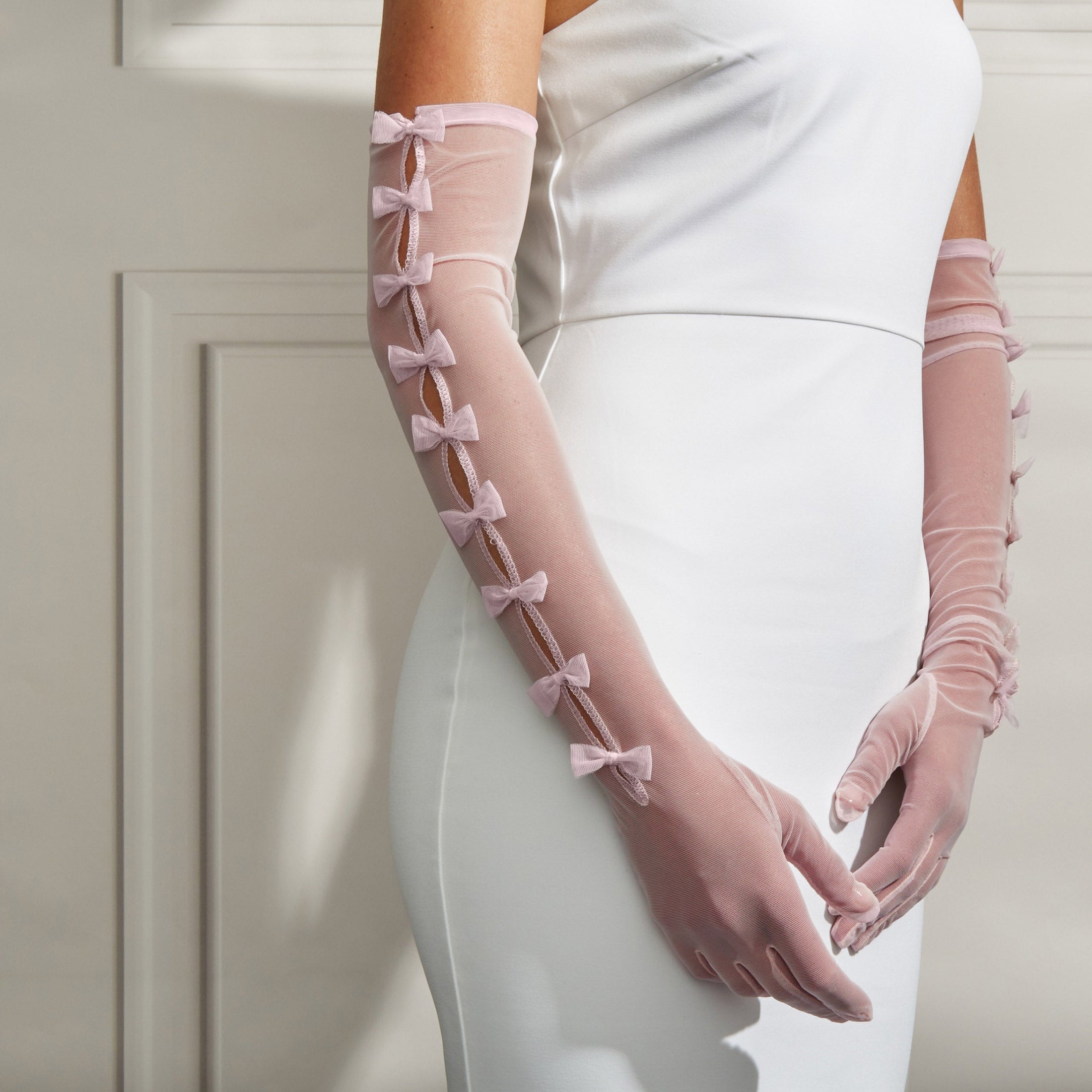woman wearing Cornelia James blush bridal gloves