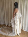 Load image into Gallery viewer, Bride wearing a white wedding dress with a lace veil against a white curtain background.
