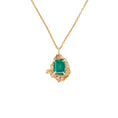 Load image into Gallery viewer, Gold necklace with an emerald pendant on a white background
