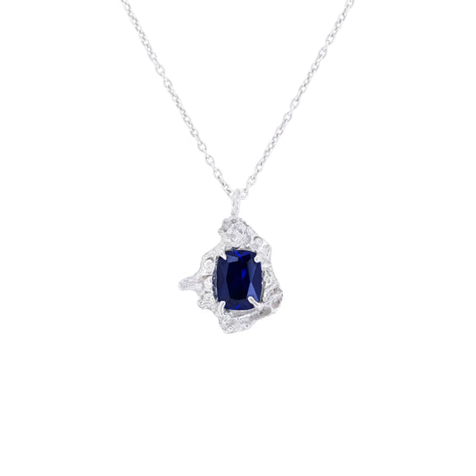 Silver necklace with a sapphire pendant on a white background