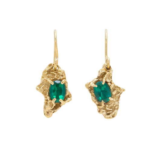 Gold earrings with emerald on a white background