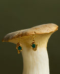Load image into Gallery viewer, Gold earrings with emeralds on a mushroom
