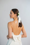 Load image into Gallery viewer, Woman wearing a white dress with a large bow, standing against a plain background

