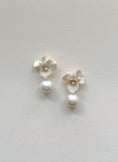 Load image into Gallery viewer, Pair of white floral earrings with pearls on a light gray background
