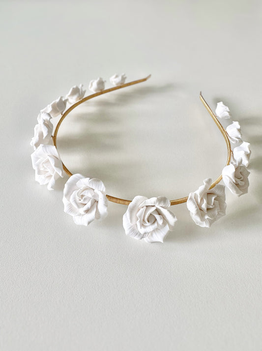 Floral headband with white flowers on a light gray background