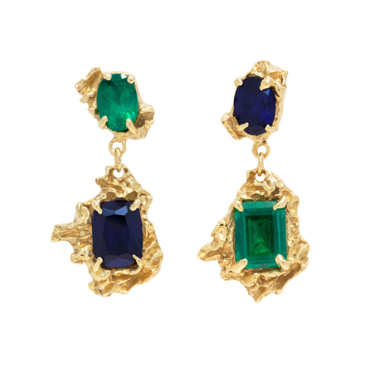Gold earrings with sapphire and emeralds on a white background