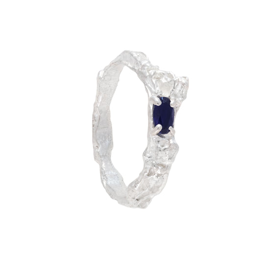 Silver ring with a sapphire on a white background
