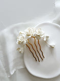 Load image into Gallery viewer, Decorative hair comb with white flowers on a white plate
