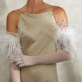 Load image into Gallery viewer, Woman wearing a beige dress with feathered bridsl gloves against a neutral background
