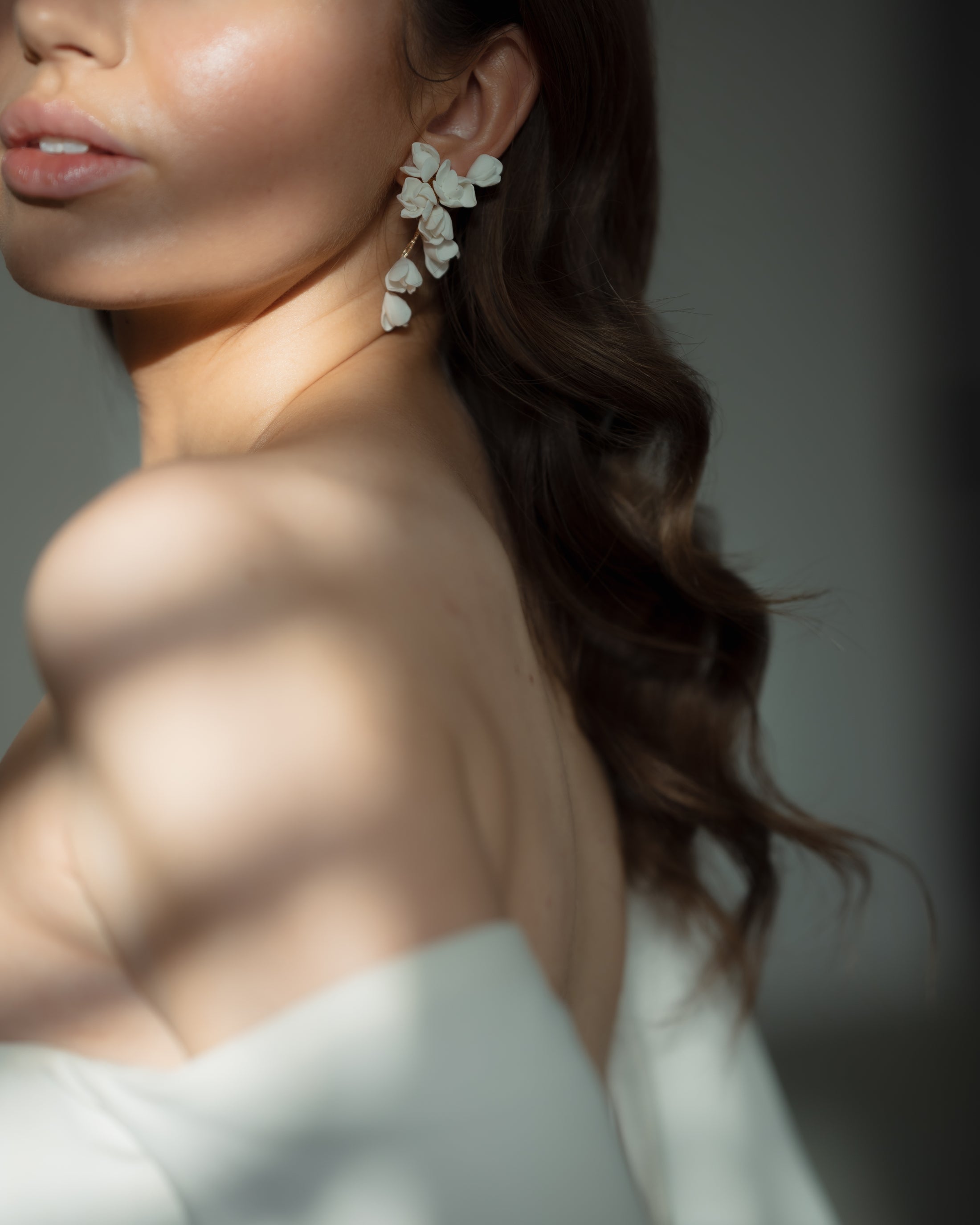 Close-up of a woman wearing elegant earrings with a blurred background