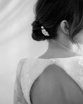 Load image into Gallery viewer, Black and white photo of a person wearing a delicate floral hair accessory.
