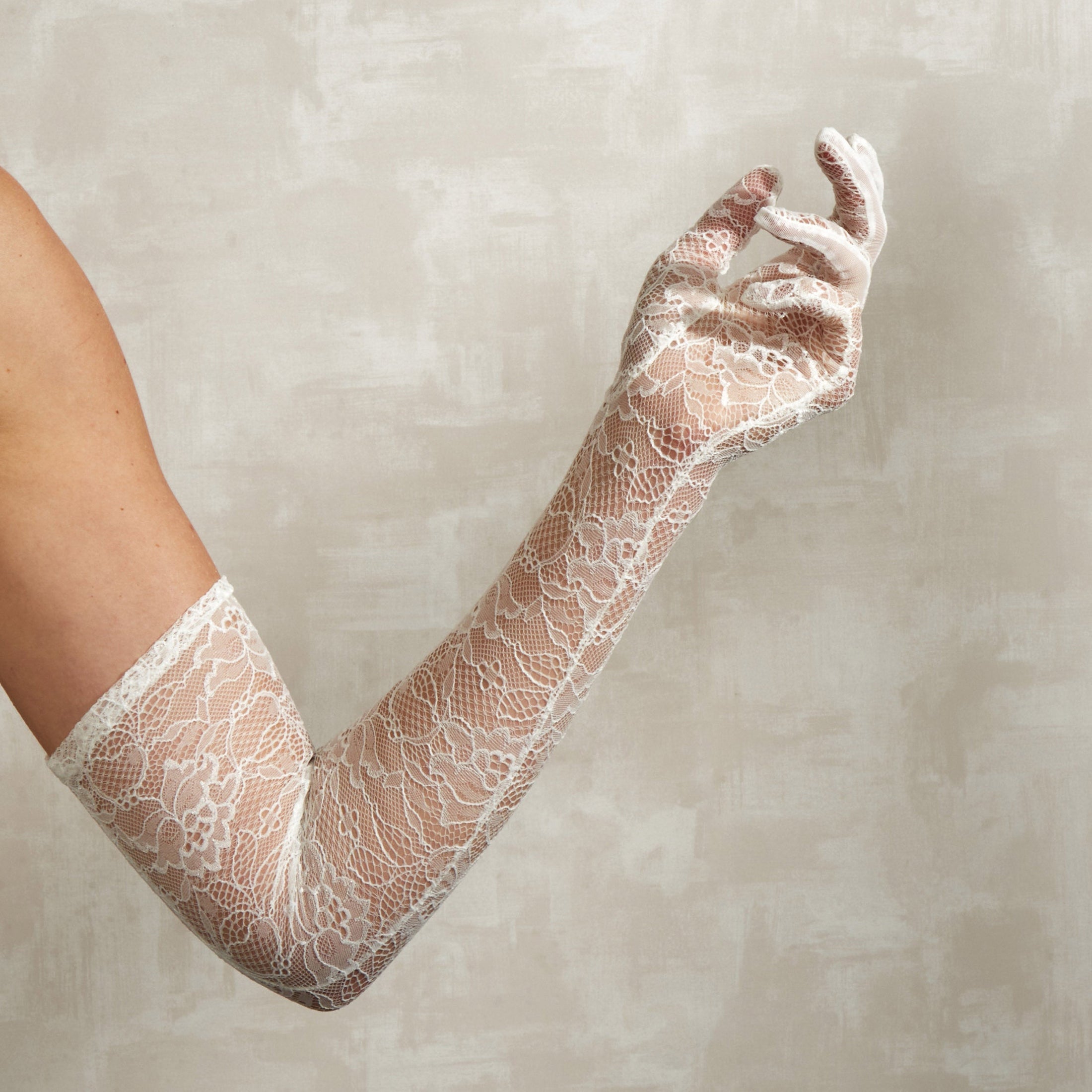 Lace bridal glove on a neutral background