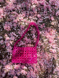 Load image into Gallery viewer, Pink beaded bridal handbag on a bed of pink flowers

