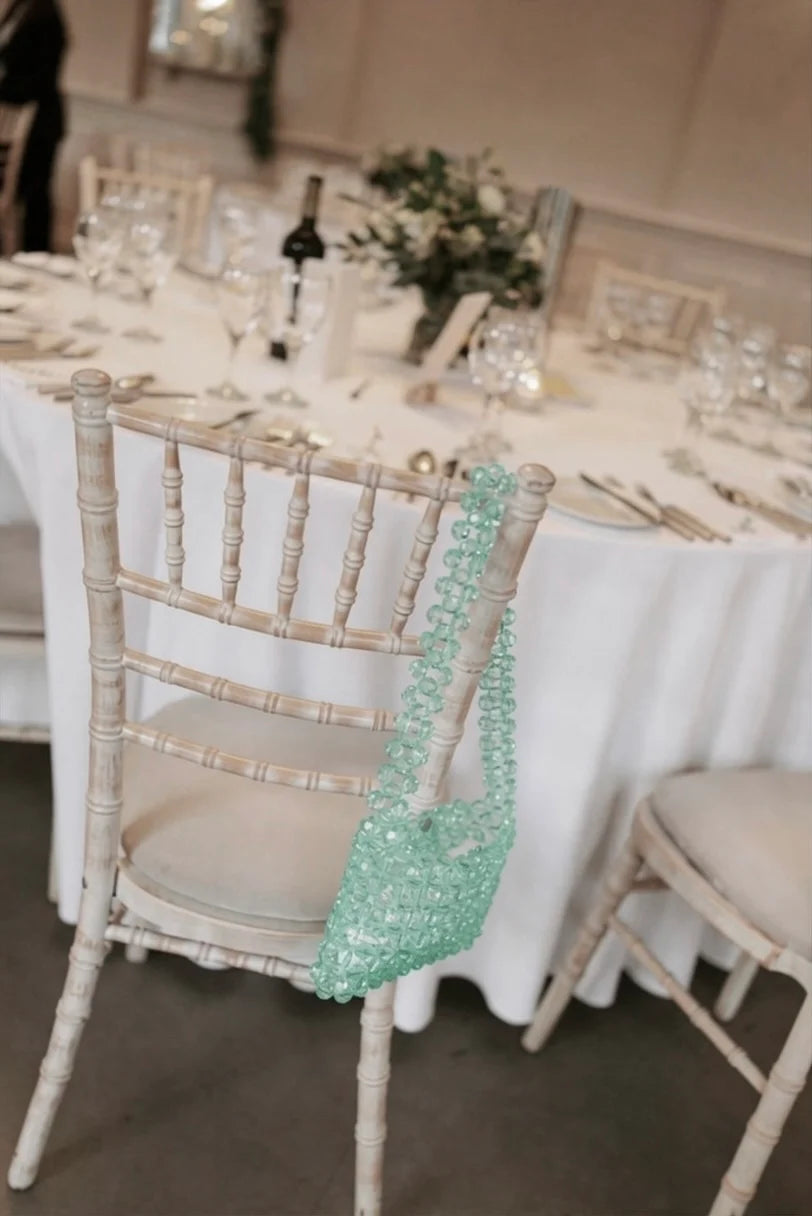 Chair with a beaded bridal handbag at a wedding table