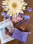 Load image into Gallery viewer, Purple beaded bridal bag with flowers and a photo on a wooden surface
