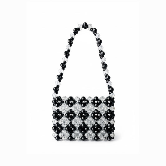 Black and white checkered bridal bag with beaded handle on a white background